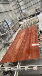 Red Travertine slabs arranged along a workshop production line