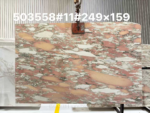 Rosa Norvegia Marble Slab with irregular rose-pink, peach and creamy white shapes in a warehouse