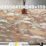 Rosa Norvegia Marble Slab with irregular rose-pink, peach and creamy white shapes in a warehouse
