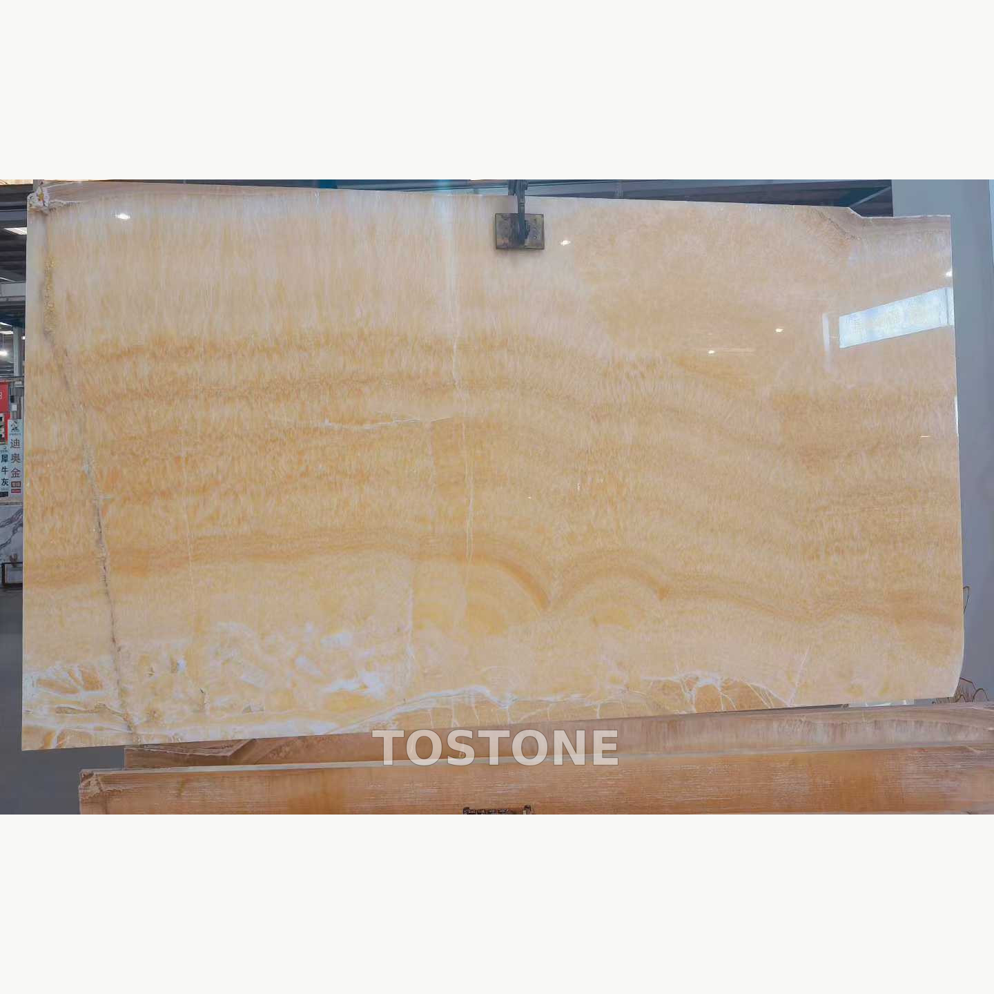 rosin-jade-marble-01-tostone-watermark-partial-clean-square Rosin Jade Marble slab with a pale honey-gold surface, cream banding and white details along the lower edge.