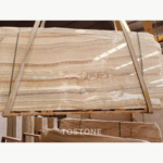 Rosin Jade Marble slab with closely layered beige, ivory and brown bands and a curled pattern near the center.
