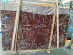 Rosso Levanto marble slab showing a dense network of pale branching veins