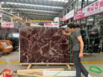 Rosso Levanto marble slab displayed in a stone showroom