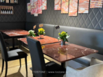 Design reference showing red marble tabletops in a dining interior
