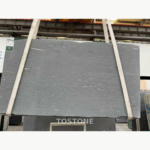Sandalwood Snow Marble slab showing scattered elongated white details across a soft grey surface.