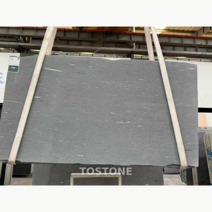 Sandalwood Snow Marble slab showing scattered elongated white details across a soft grey surface.