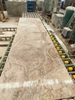 Cross-cut Silver Travertine slab on a production line showing flowing arcs