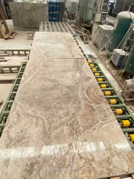 Cross-cut Silver Travertine slab on a production line showing flowing arcs