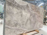 Angled Silver Travertine cross-cut slab with curving cream bands