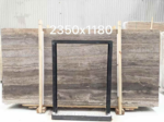 Silver Travertine vein-cut slab displayed behind a handling frame