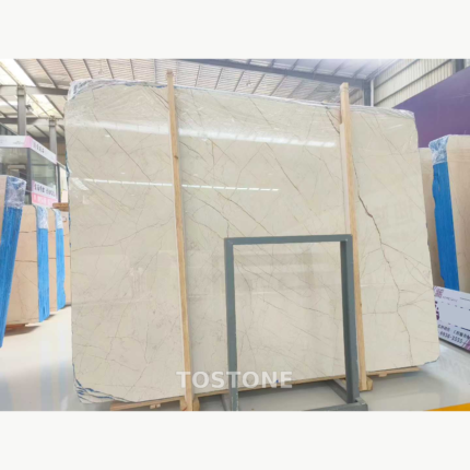 Sofitel Gold Marble slab bundle with a cream background and fine crossing taupe veins behind wooden braces.