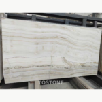 Straight Vein White Jade Marble slab showing parallel white and pale grey bands with tan accents and darker irregular lines.