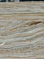 Close view of Tilamisu Travertine Slab with cream, beige and dark wavy bands