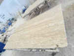 Turkish cream travertine slab viewed diagonally, showing natural cream layers and earthy beige markings