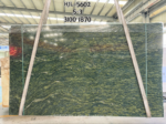 Verde Fantastico marble slab displaying wavy golden-green veining across a dark green background