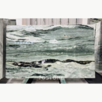 Victoria Green Marble slab with pale green and white layers above a bold charcoal band near the lower third.