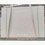 Angled Vietnam Crystal White Marble slab bundle with soft white-grey clouding and original image annotations