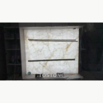 Illuminated White Crystal Marble wall panel with layered white patterning and soft gold veins during installation.