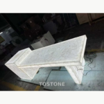 Illuminated White Crystal Marble counter assembly in a workshop, showing fine grey veining across its white surface.