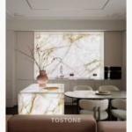 Alternate crop of a kitchen design reference featuring White Crystal Marble, an illuminated backsplash and a waterfall island.