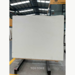 Full White Sand Beige Marble slab with an ivory-beige background, faint gray markings and an uneven upper edge.
