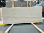 Wide White Travertine Slab with soft horizontal gray bands on timber supports