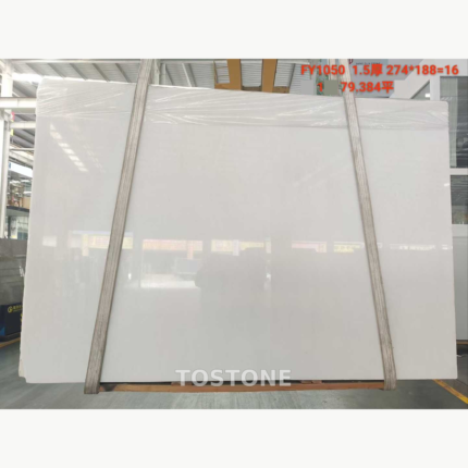 Ya Shi White Jade Marble slab under lifting straps, showing a soft white face and faint grey shading